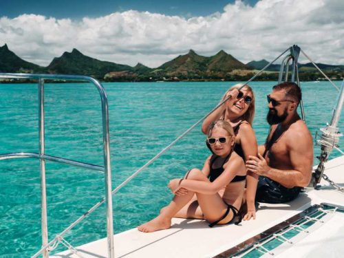 800- Mauritius - a-happy-family-in-swimsuits-sits-on-a-catamaran-in-the-indian-ocean-portrait-of-a-family-on-a-yacht-in-the-coral-reef-of-the-island-of-mauritius