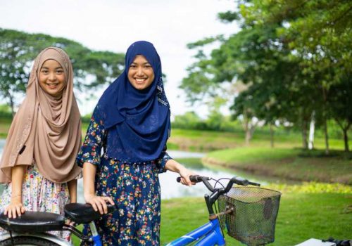 800 - Phuket, Yao Noi, Khao Sok - two-muslim-woman-ride-bicycle-in-the-garden