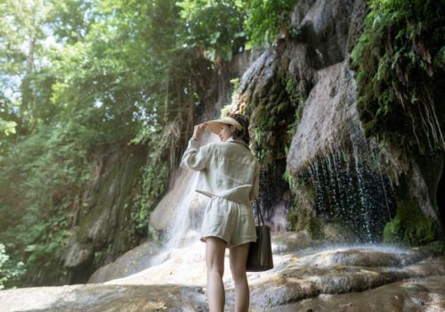 800 - River Kwai - back-side-of-woman-with-waterfall-in-tropical-rainforest-with-rock-saiyok-noi-waterfall(1)