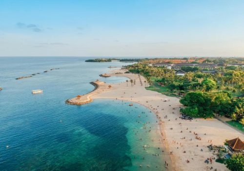 800x600 - Baliaerial-drone-view-of-holiday-in-sanur-beach-bali-indonesia-with-ocean-boats-beach-villas-and-people